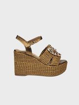 A pair of gold wedge sandals for women featuring a stylish buckle detail.