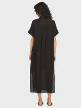 Black shirt dress crafted from linen, featuring a relaxed fit and versatile design for various occasions.