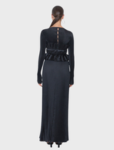 Sophisticated black gown with a high neckline, long sleeves, and detailed pleats, offering a flattering silhouette.