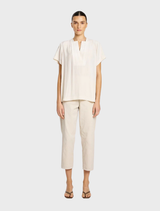  Light meringue-colored double vent top, featuring a stylish design suitable for casual or formal occasions.
