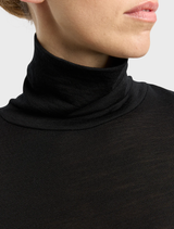 Black turtle neck merino tee laid flat, emphasizing its classic style and high-quality material.