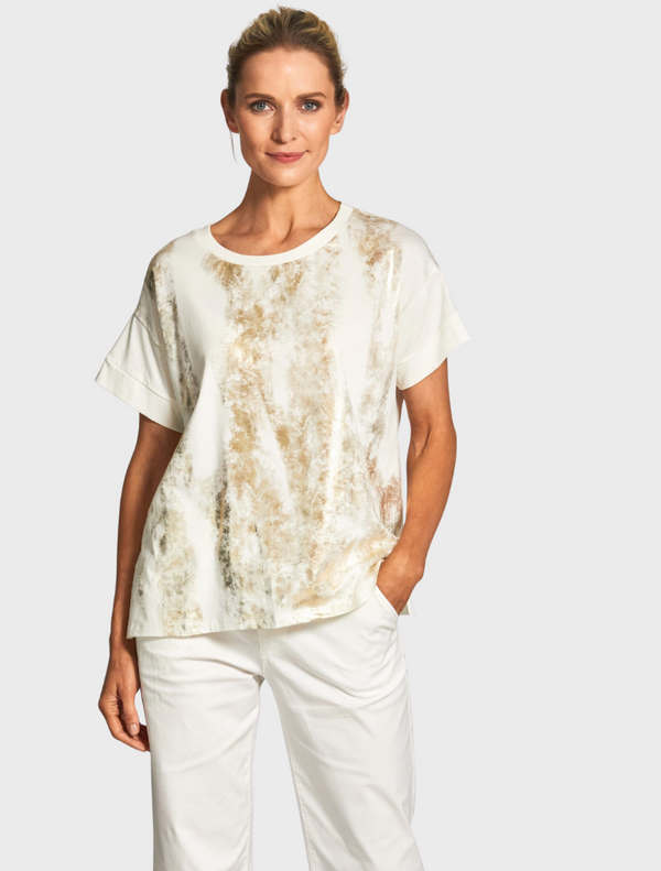 A white top crafted from a vibrant tie-dye fabric, showcasing a unique blend of colors and patterns.
