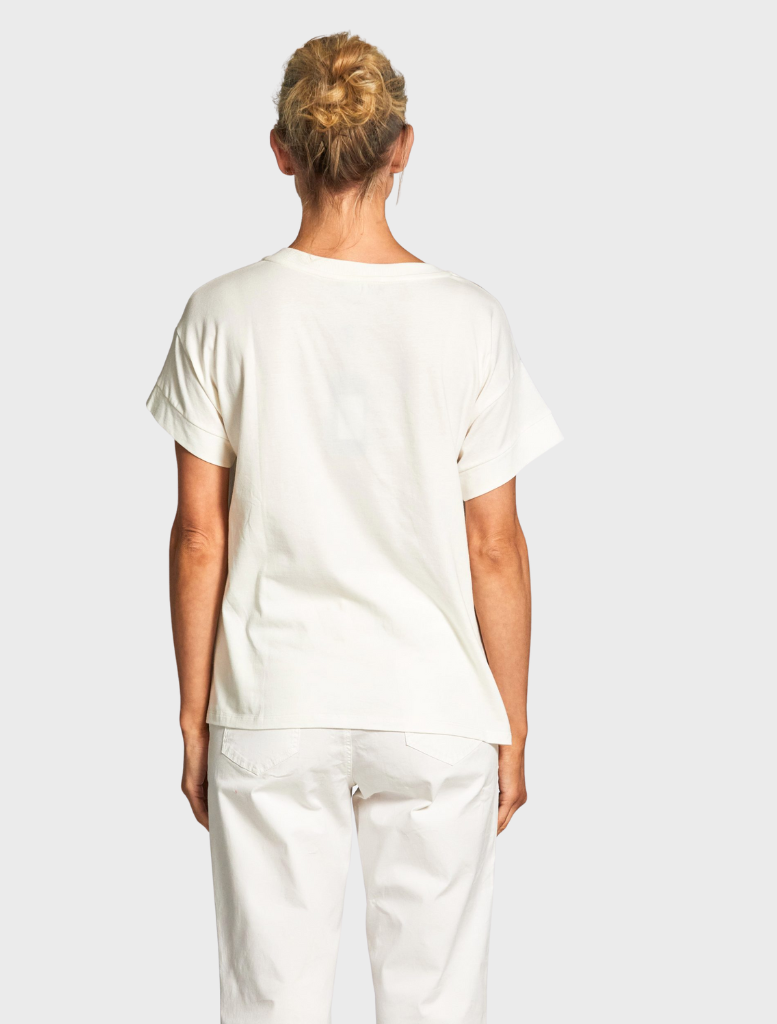 A white top with a distinctive tie-dye pattern, emphasizing its creative and colorful fabric design.