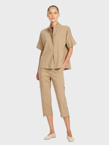 Elevated Tab Shell in Microprene features a button closure at the neck, short sleeves, and a relaxed fit for comfort.