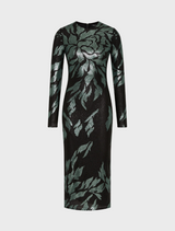 A woman showcases the Larissa Midi Dress in Mint Black, characterized by its black fabric and green leaf motifs.