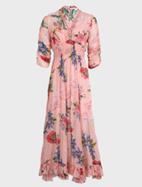 Pink floral dress with a fitted bodice and flared skirt, showcasing a vibrant flower pattern for a cheerful look.