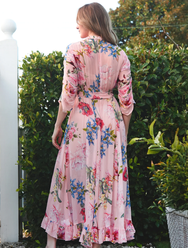 Charming pink floral dress with a cinched waist and a flared silhouette, ideal for casual or semi-formal events.