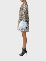 Fluid mini shirt dress with feather details, celebrating flamenco culture through its unique print and elegant draping.