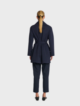 A chic wrap trench coat in deep ink hue, designed with a belted waist and a tailored collar for a polished look.