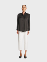 A soft mink shirt laid flat, highlighting its gentle fabric and elegant design.
