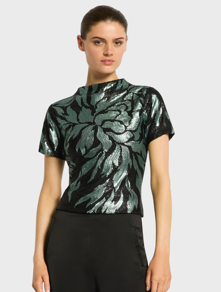 A model wears the Larissa Top Mint Black, complemented by fashionable wide-leg pants.