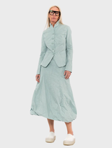 A mint-colored poplin skirt adorned with a lively print, perfect for adding a fresh touch to any outfit.