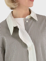 Close-up of a grey Mira blouse, emphasizing its fabric and design details.