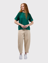 Emerald mixed media tee featuring a round neck, low raglan seams, and contrasting linen front and cuffs.