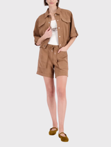 Model in a mocca jacket, emphasizing its lightweight fabric and sophisticated design elements.