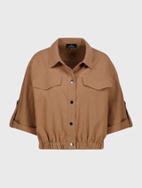 Model in a high-quality modal blend jacket, featuring a snap button placket and fake flap pockets, perfect for contemporary fashion.
