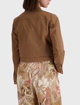 Elegant cropped mocca trench jacket with a stand-up collar and detailed sleeve hems, showcasing modern style and fine material.