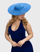 Modern cobalt blue racewear hat featuring a sculptural design and fitted headband for comfort and versatility in styling.