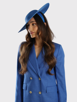 Stylish royal blue racewear hat with a minimalist aesthetic, designed for comfort and versatility in hair styling.
