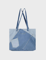  A close-up of a textured denim fabric, showcasing its blue hue and distinct stitching patterns throughout.