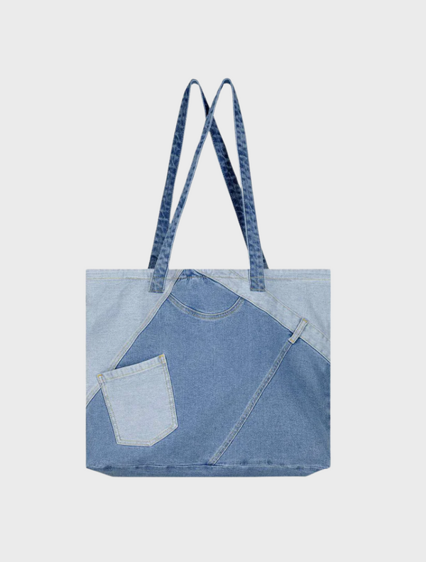  A close-up of a textured denim fabric, showcasing its blue hue and distinct stitching patterns throughout.