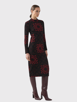 Fitted shift dress in red and black baroque pattern, with long sleeves, high neckline, and center back zip closure.