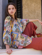 Stylish floaty blouse with V neckline, elastic cuffs on blouson sleeves, and intricate custom embroidery on the placket.
