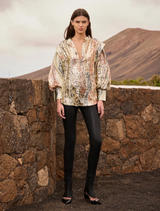 Luminous multicolor jacquard shirt featuring voluminous sleeves, tulle lining, and a refined button placket for modern elegance.