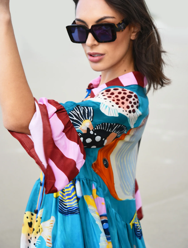 Vibrant dress adorned with a playful multi-fish pattern, ideal for warm weather events or seaside gatherings.