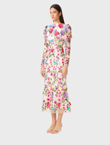 Long sleeve midi dress with a vibrant multi floral pattern, draped gracefully over a display stand.
