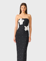 Elegant black maxi dress with strapless design, intricate white floral embellishments, and a refined, feminine silhouette.