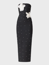 Elegant black maxi dress with strapless design, adorned with white beaded florals and pearl detailing for a sophisticated look.
