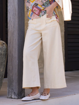 The Navi Pants in Buttermilk offer a flattering fit with elastic waist, frayed edges, and a clean, modern design.