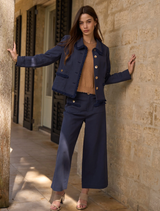 Navy jacket made of linen blend, featuring frayed edges, trim details, and panel seams for a perfect fit. Fully lined.