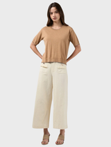 Buttermilk Navi Pants feature a linen blend, elastic back waist, and frayed edges for a relaxed, stylish look.