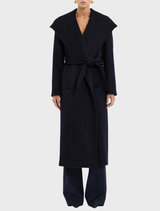 Elegant navy Bower Coat hanging, showcasing a modern silhouette and refined style suitable for various occasions.