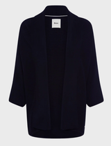 Black knit cardigan displayed against a navy background, showcasing its texture and design.