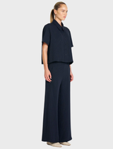 Navy and chalk striped crop shirt with a smooth finish, featuring a classic collar and button placket, made from Flex Weave.