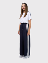 Navy/white wide leg pant with elasticated waist, flat front, adjustable ties, and contrasting tape along the side seams.