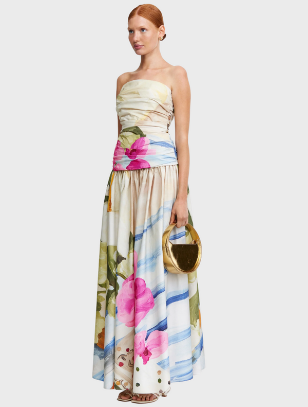 The model is dressed in a stylish floral print dress, adorned with a variety of colorful blooms.