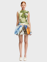 A model showcases a floral print skirt, highlighting its vibrant colors and elegant design.