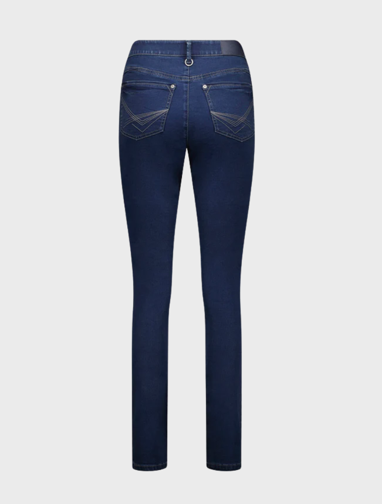 Indigo jeans stand confidently, showcasing a casual yet stylish outfit.