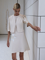 Trendy Nikita short dress in a soft straw tone, perfect for daytime wear or evening gatherings.