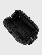 Stylish black clutch with vegan leather, gold hardware, and a roomy interior, perfect for events and daily use.