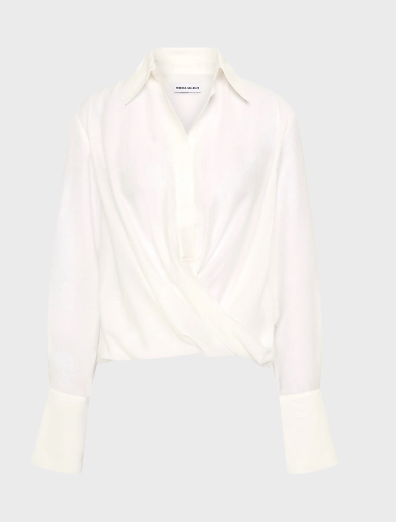 A white long-sleeve shirt is open, showcasing its relaxed fit and simple design.