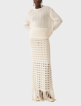 Elegant off-white knit skirt featuring fringed detailing, ideal for adding a stylish touch to any outfit.