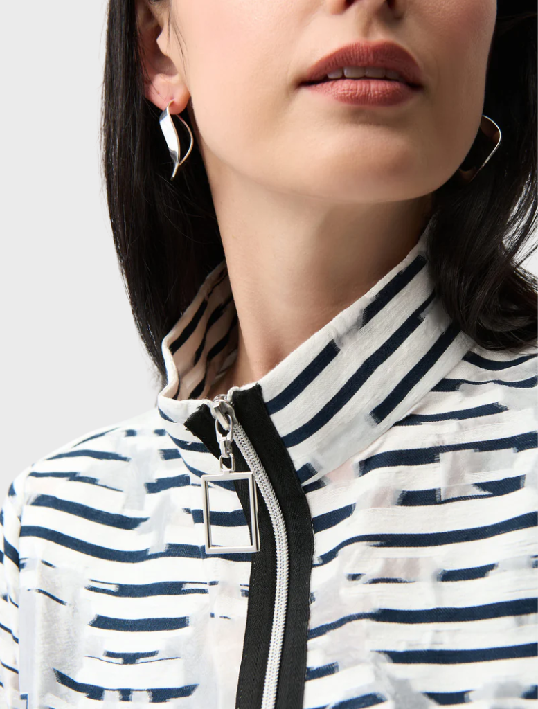 A stylish off-white and navy jacket hanging, featuring a contemporary design ideal for both casual and semi-formal occasions.