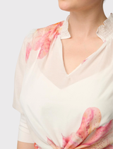 This refined Oleander Blouse in Nautilus Bloom is constructed from a cotton-silk blend, featuring a shirred collar and gathered sleeves.