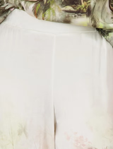 Elegant satin-look palazzo pants in olive with a vibrant tropical print, designed for comfort in summer.