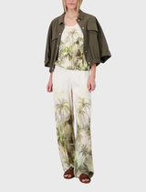 Olive tropical print palazzo pants made from lightweight fabric with an elegant satin finish, perfect for summer wear.
